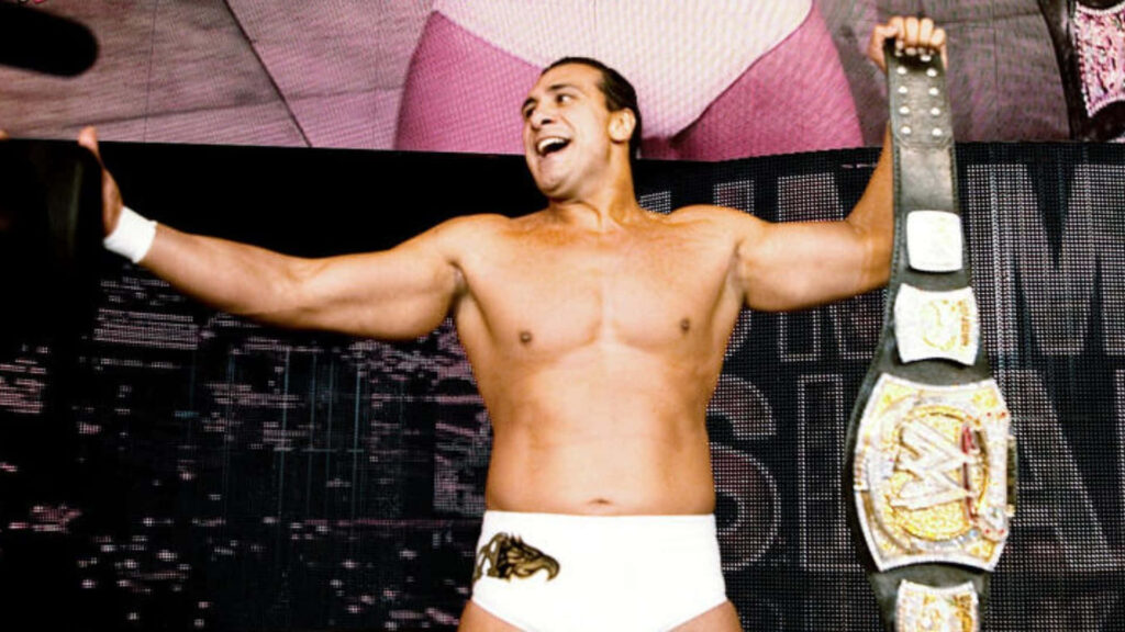 WWE superstar Alberto Del Rio holds championship belt high celebrating victory in wrestling ring Wallpaper