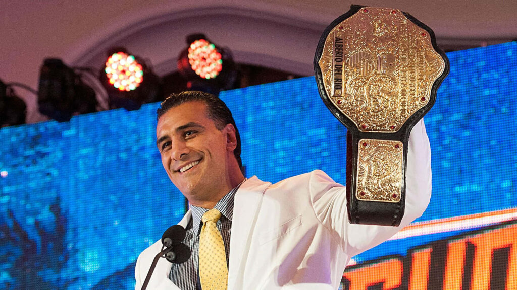 Alberto Del Rio in white suit holding WWE Championship belt on vibrant stage wallpaper background