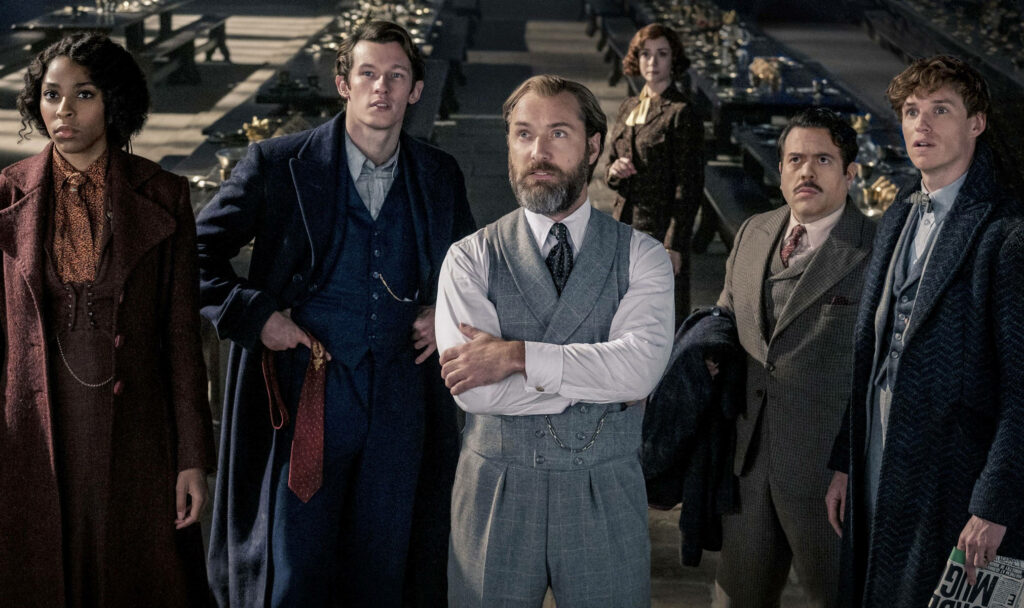 Jude Law as Albus Dumbledore with main characters in magical Fantastic Beasts wallpaper background