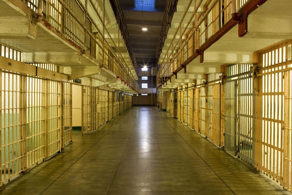 Alcatraz prison corridor wallpaper dark moody industrial lighting historic jail interior background