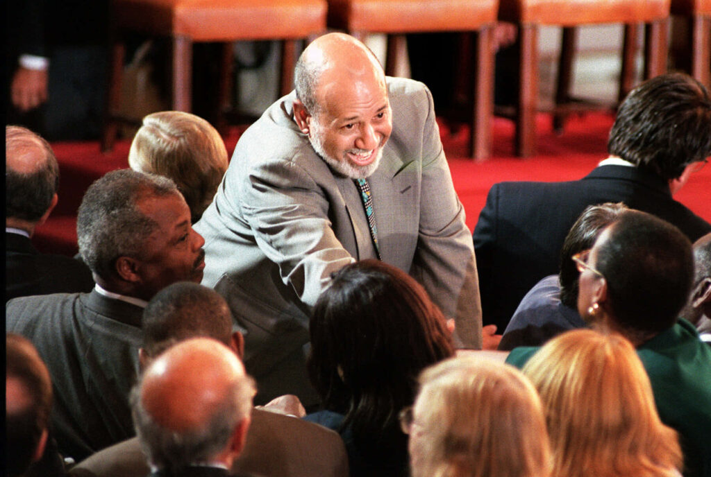 Alcee Hastings warmly shaking hands with audience members during public engagement event wallpaper background