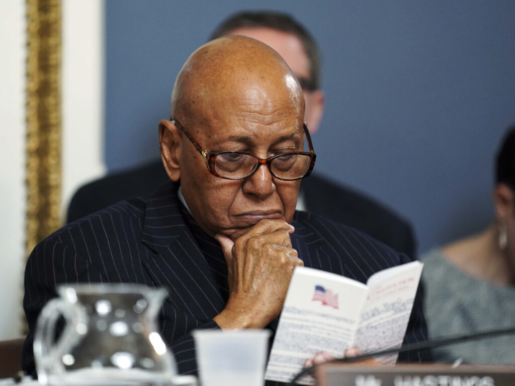 Alcee Hastings focused reading document formal setting wallpaper background American politician