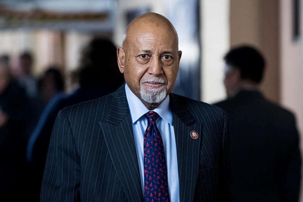 Alcee Hastings in pinstripe suit and vibrant tie with somber expression formal political portrait wallpaper