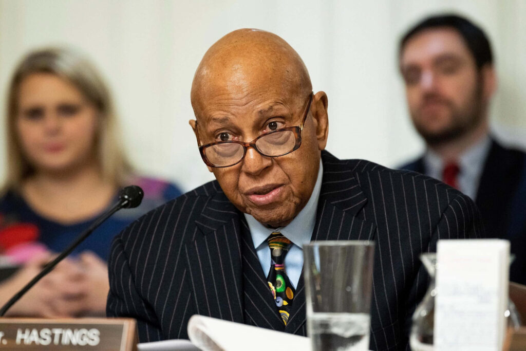 Alcee Hastings in pinstripe suit and glasses thoughtful experienced American politician formal meeting Wallpaper