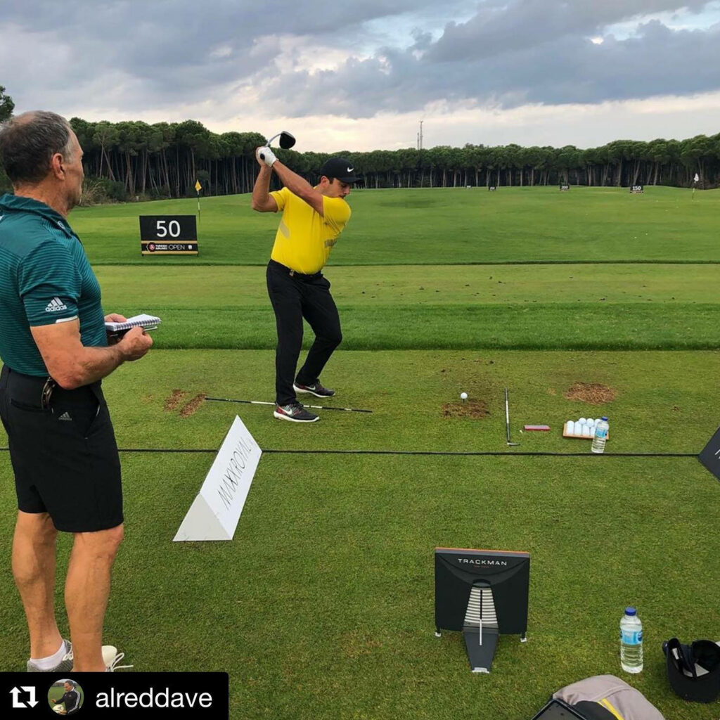 Aldred Watches Francesco Molinari Golf Practice on Lush Course Wallpaper