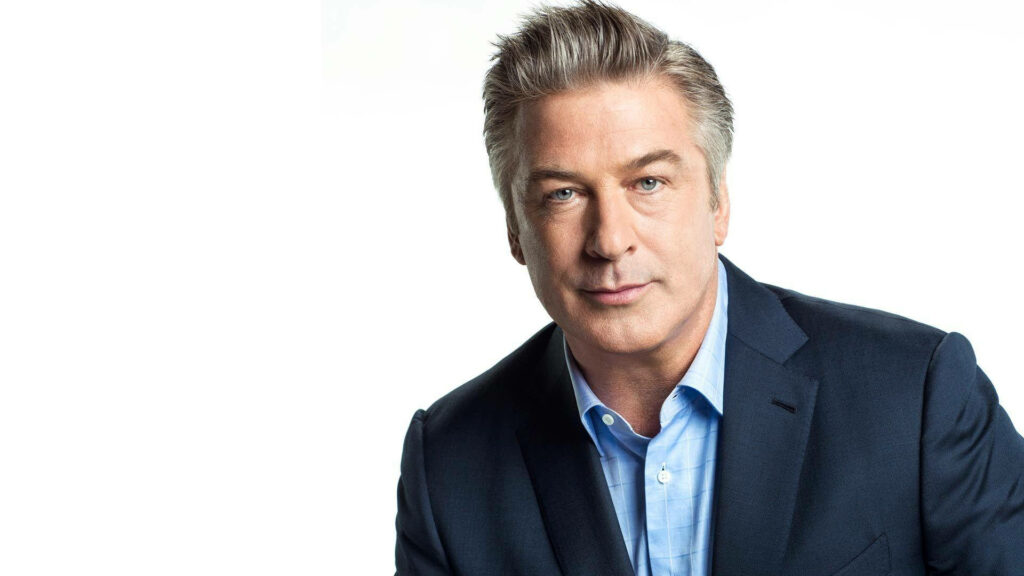 Alec Baldwin in stylish blue suit posing confidently on clean white background photoshoot wallpaper