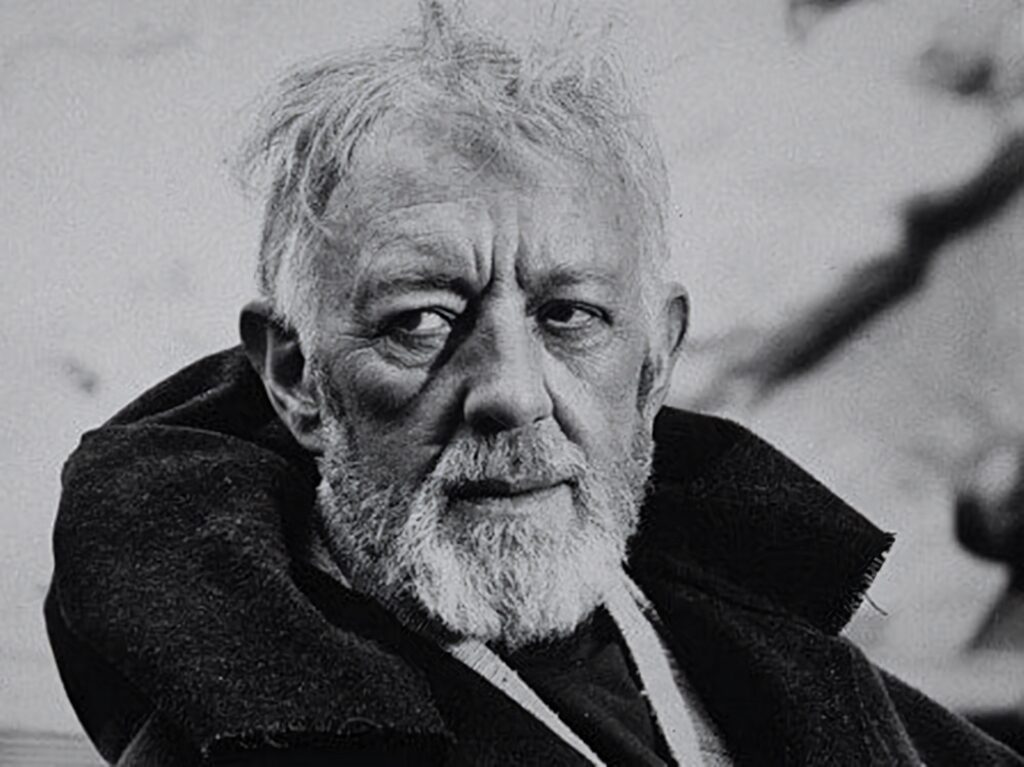 Monochrome portrait of Alec Guinness with expressive gaze and distinguished features wallpaper