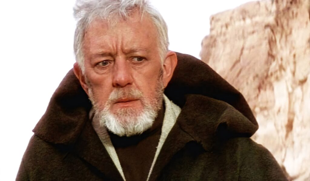 Alec Guinness portrait wallpaper contemplative gaze dark robe rugged landscape background