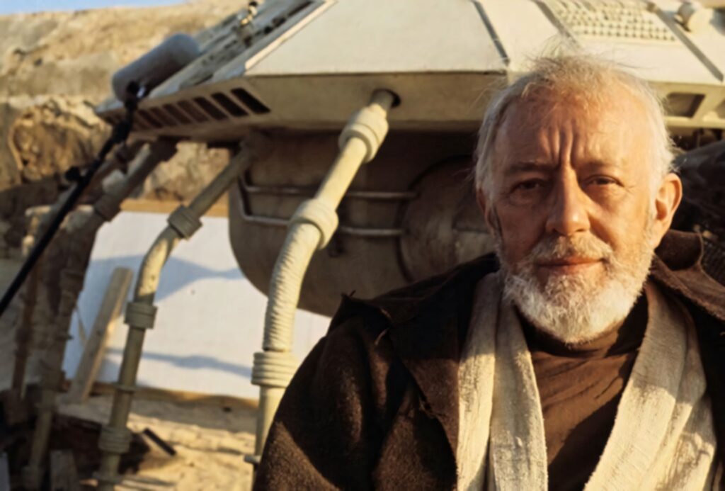 Alec Guinness as Obi Wan Kenobi stands by rugged spacecraft on desert planet Star Wars wallpaper background