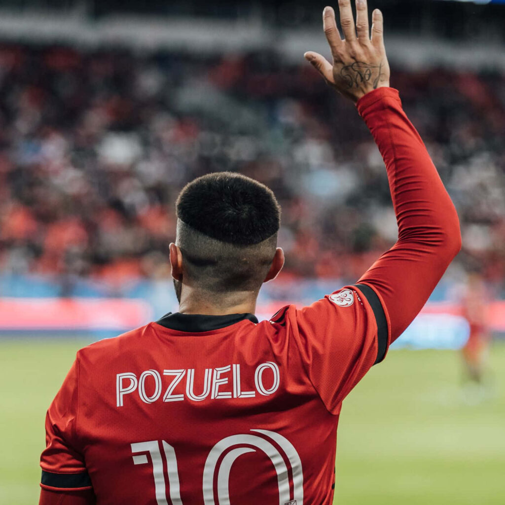 Alejandro Pozuelo number 10 footballer raising hand to crowd on vibrant stadium field wallpaper