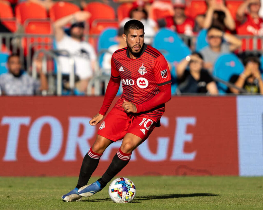 Alejandro Pozuelo Toronto FC soccer player controlling ball focused during match on field wallpaper
