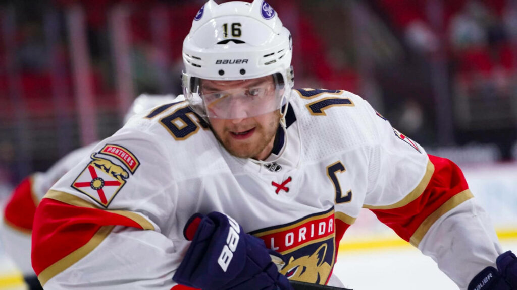 Aleksander Barkov in Florida Panthers jersey focused on ice hockey game intense leadership Wallpaper