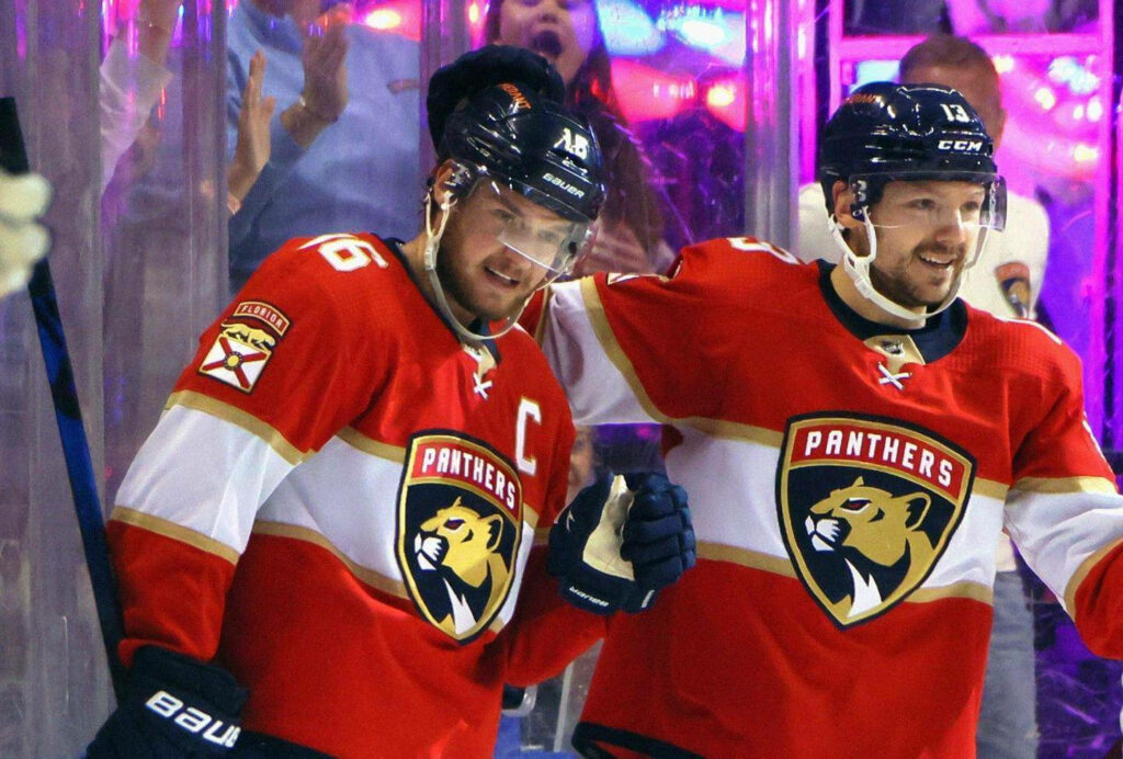 Aleksander Barkov and Jonathan Huberdeau Florida Panthers celebrate on ice in red uniforms wallpaper