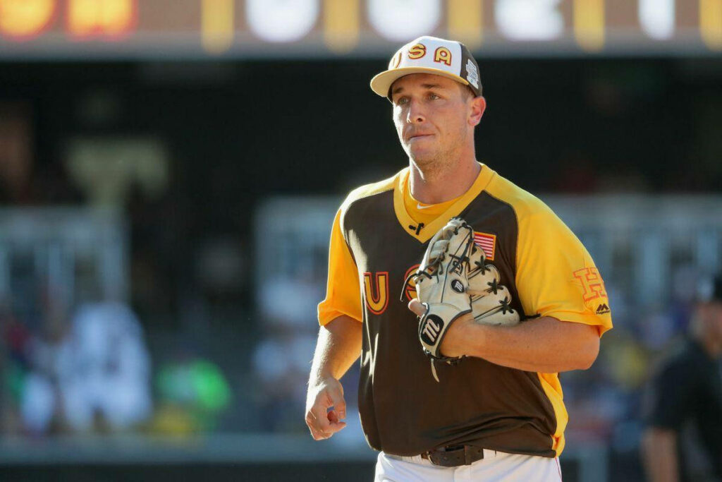 Alex Bregman in team uniform holds glove to chest on baseball field during game wallpaper background