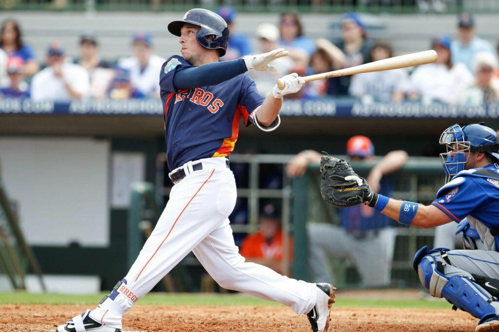 Alex Bregman swinging bat and running during baseball game showcasing athleticism and focus Wallpaper