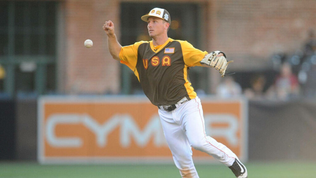 Alex Bregman in USA jersey focused catching baseball on field dynamic sports wallpaper background