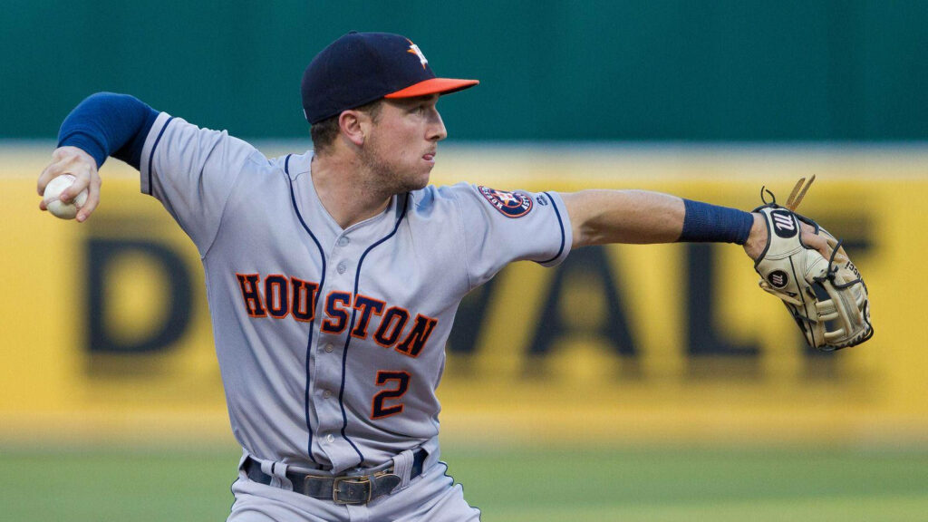 Alex Bregman in Houston Astros uniform preparing to throw baseball on field action wallpaper