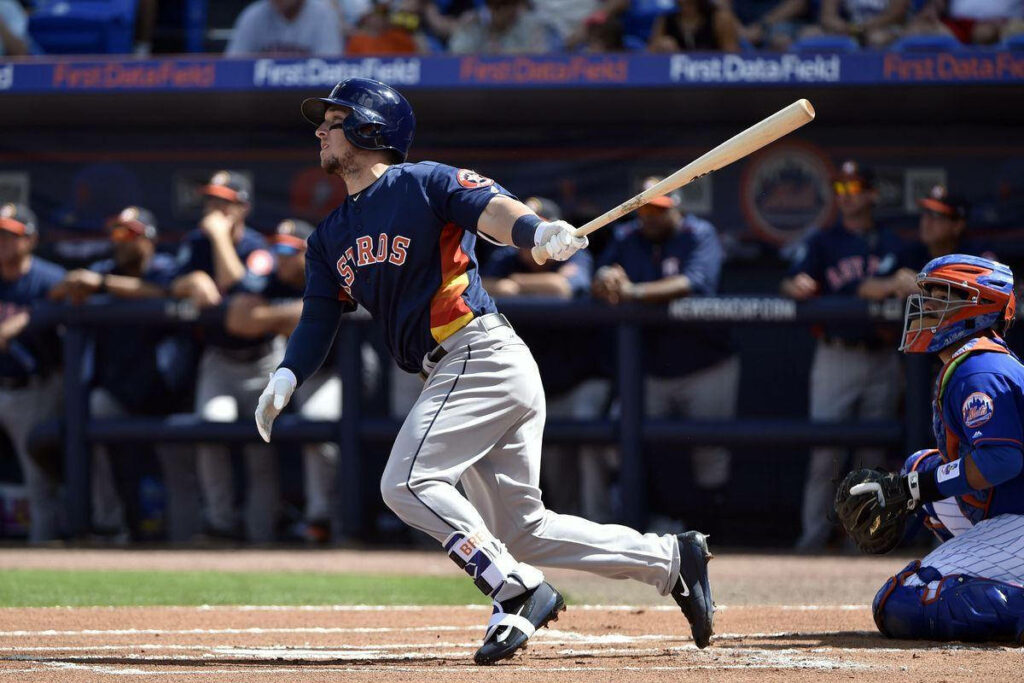 Alex Bregman running with bat in Houston Astros uniform during baseball game on field wallpaper