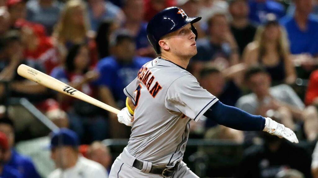 Alex Bregman focused upward after hitting baseball showing determination in baseball game action Wallpaper