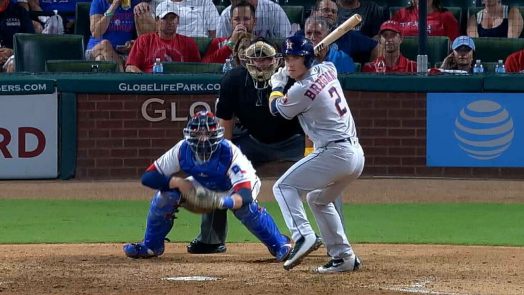 Alex Bregman focused at the plate raising foot ready to swing during intense baseball game Wallpaper