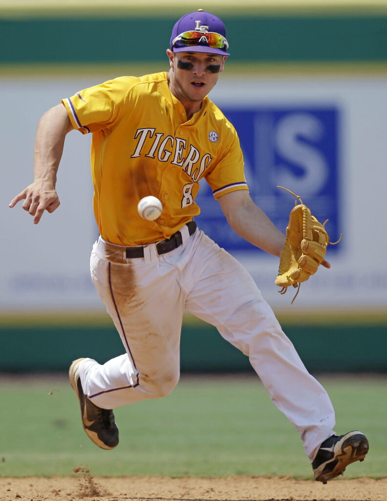 Alex Bregman running toward baseball in vibrant gold Tigers uniform showing athleticism wallpaper