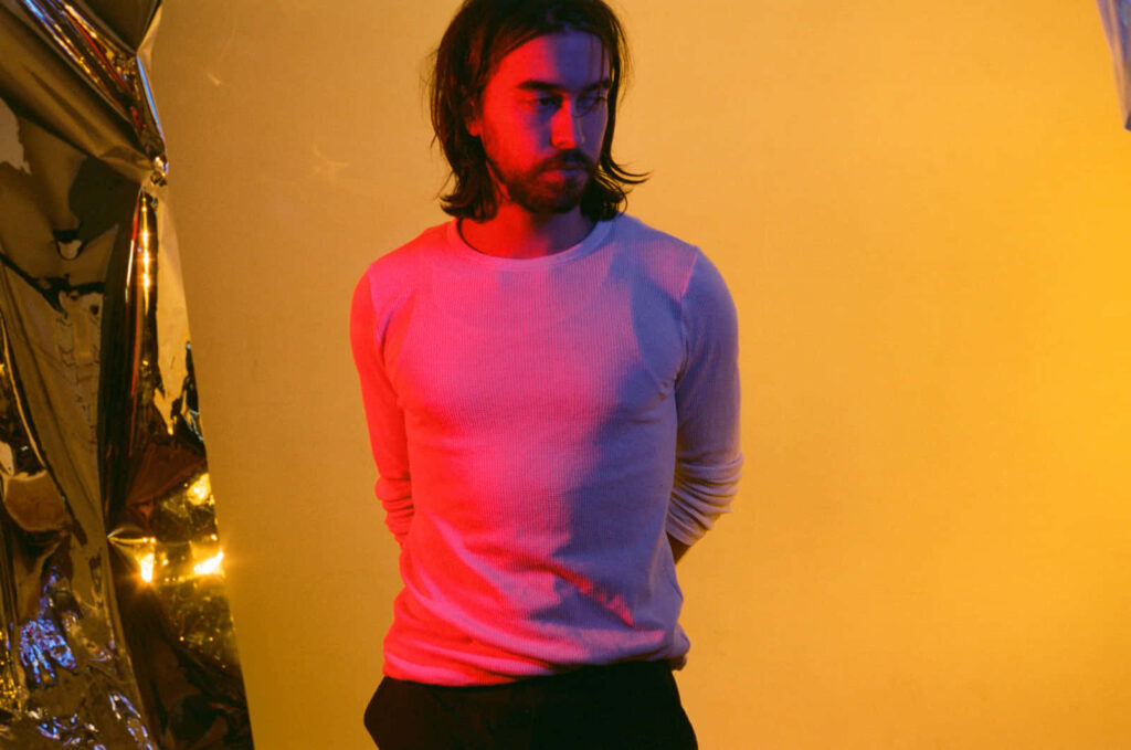 Alex G portrait vibrant yellow background colorful lighting moody artistic wallpaper backdrop