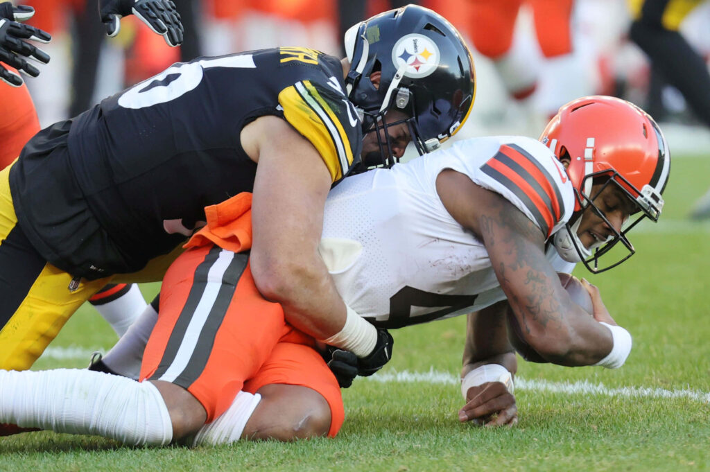 Alex Highsmith powerful football tackle intense action dynamic sports wallpaper background