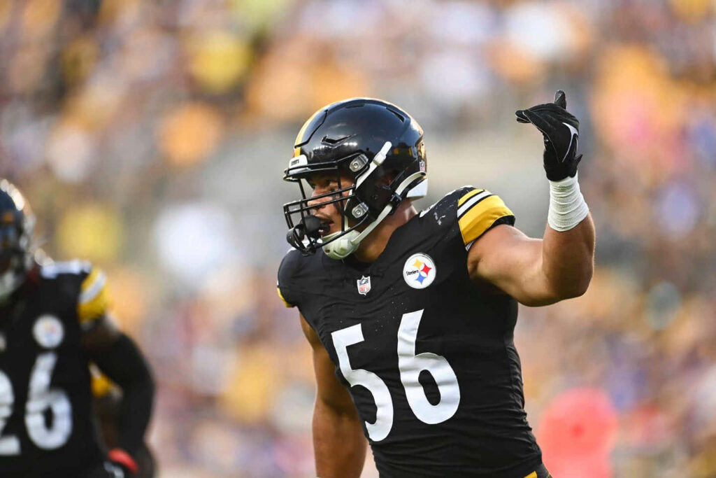 Alex Highsmith in Pittsburgh Steelers uniform making dynamic play action on football field wallpaper