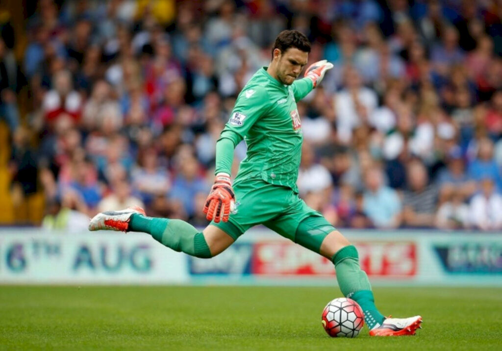 Alex McCarthy goal keeper skillfully kicking soccer ball during match showing focus and athleticism Wallpaper