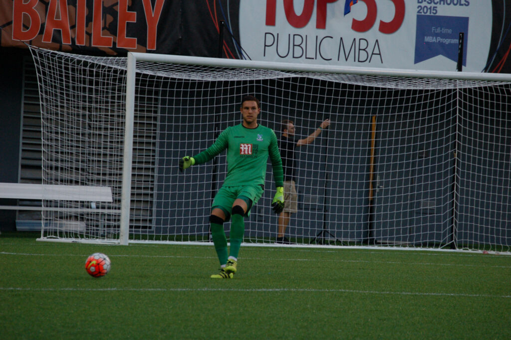 Alex McCarthy focused goalkeeper ready to distribute ball in match showcasing skill and composure Wallpaper