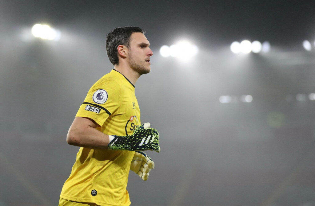 Alex McCarthy goalkeeper focused on pitch during night match in brightly lit stadium wallpaper background