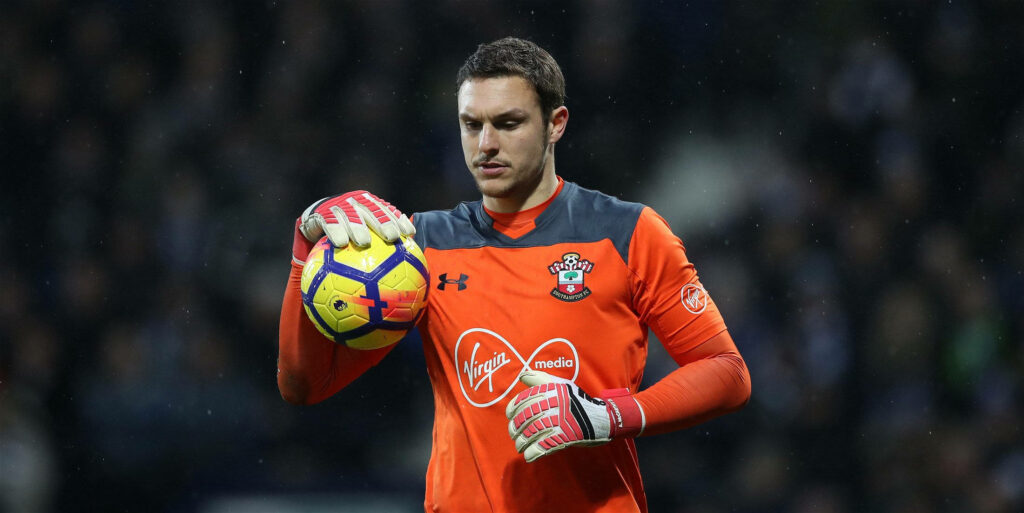 Alex McCarthy in goalkeeper kit holding soccer ball focused during match wallpaper background