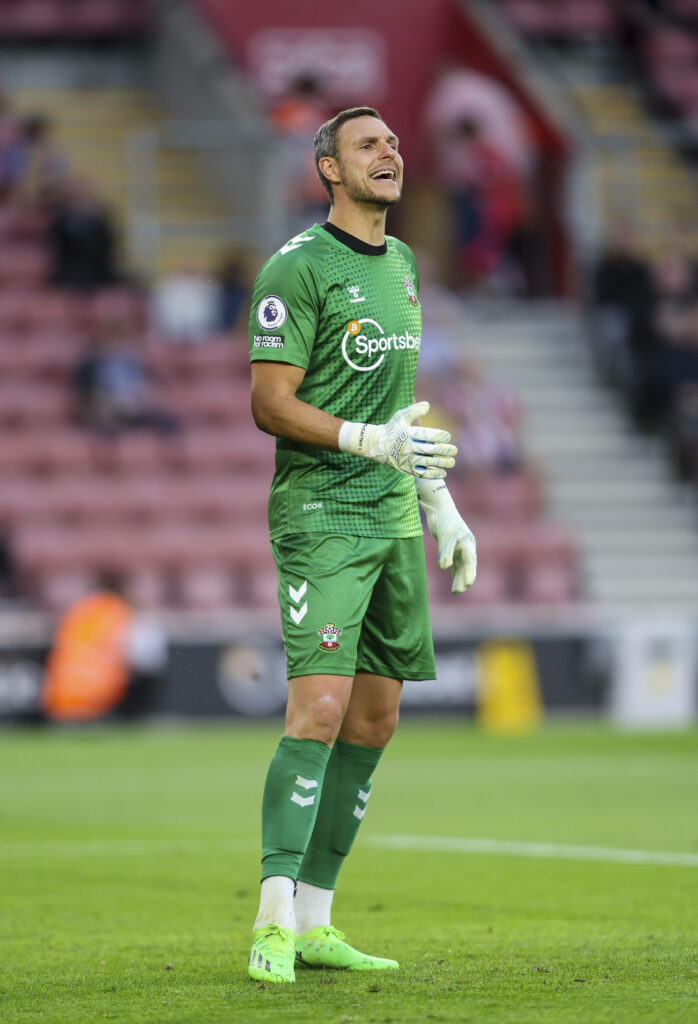 Alex McCarthy in green goalkeeper kit standing on football pitch ready for action at stadium Wallpaper