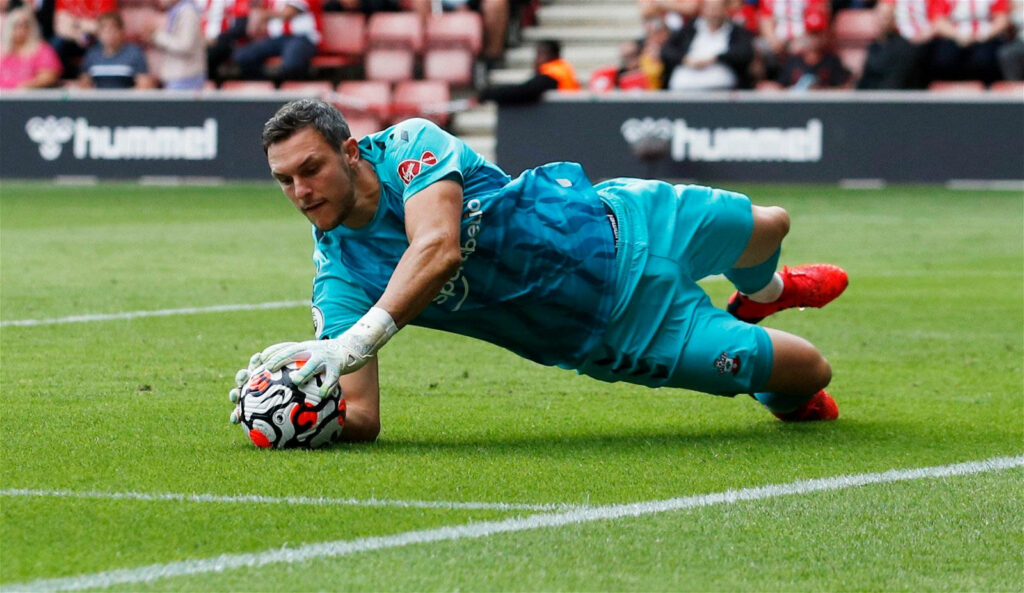 Alex McCarthy diving to catch soccer ball showcasing expert goalkeeping skills in match action Wallpaper