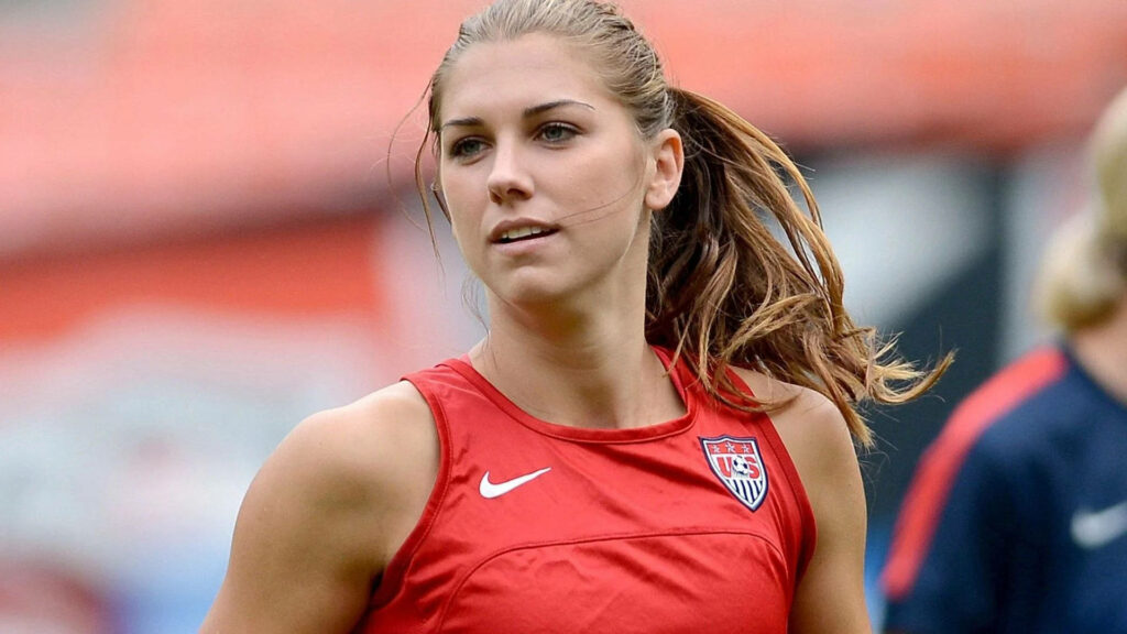 Alex Morgan Team USA soccer player focused in action dynamic wallpaper background athleticism