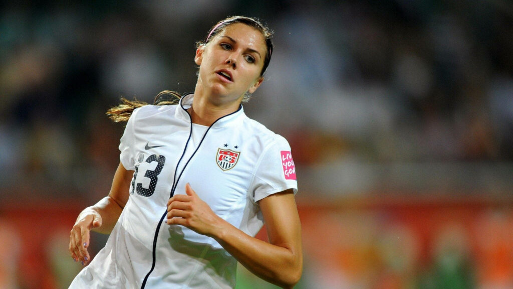 Alex Morgan in US Team jersey focused on soccer field action dynamic wallpaper background