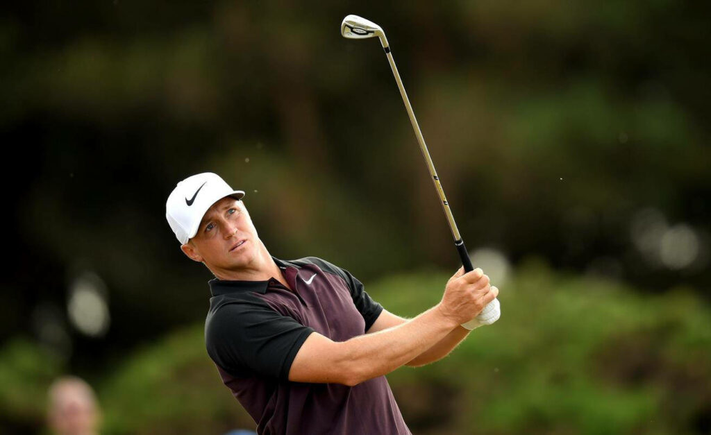 Alex Norén mid golf swing focused poised golfer on lush green course natural wallpaper background