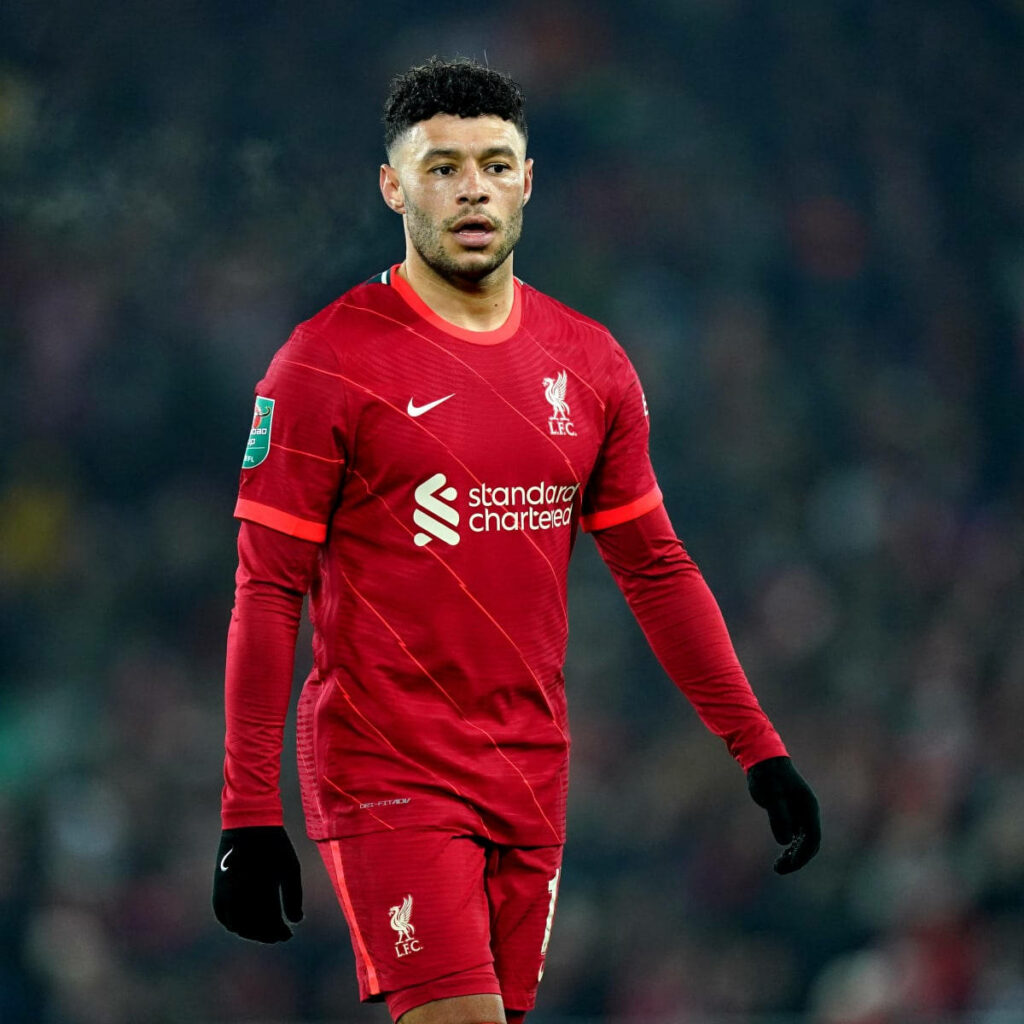 Alex Oxlade-Chamberlain in Liverpool FC kit walking on field showing focus during match Wallpaper