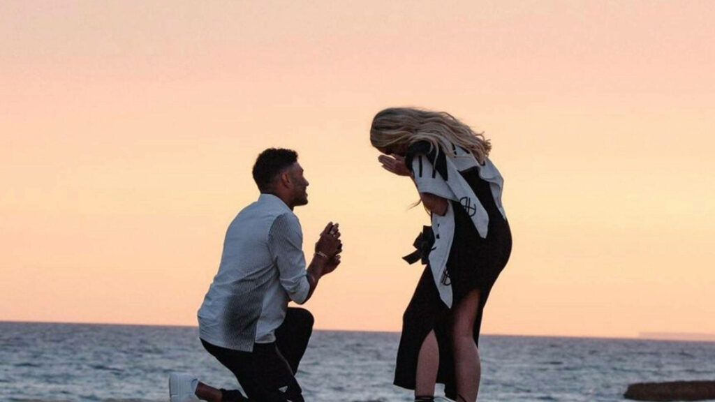 Alex Oxlade-Chamberlain proposes to Perrie Edwards by ocean sunset romantic wallpaper background