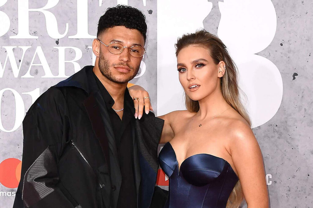 Alex Oxlade-Chamberlain and Perrie Edwards stylish on red carpet in elegant attire wallpaper background