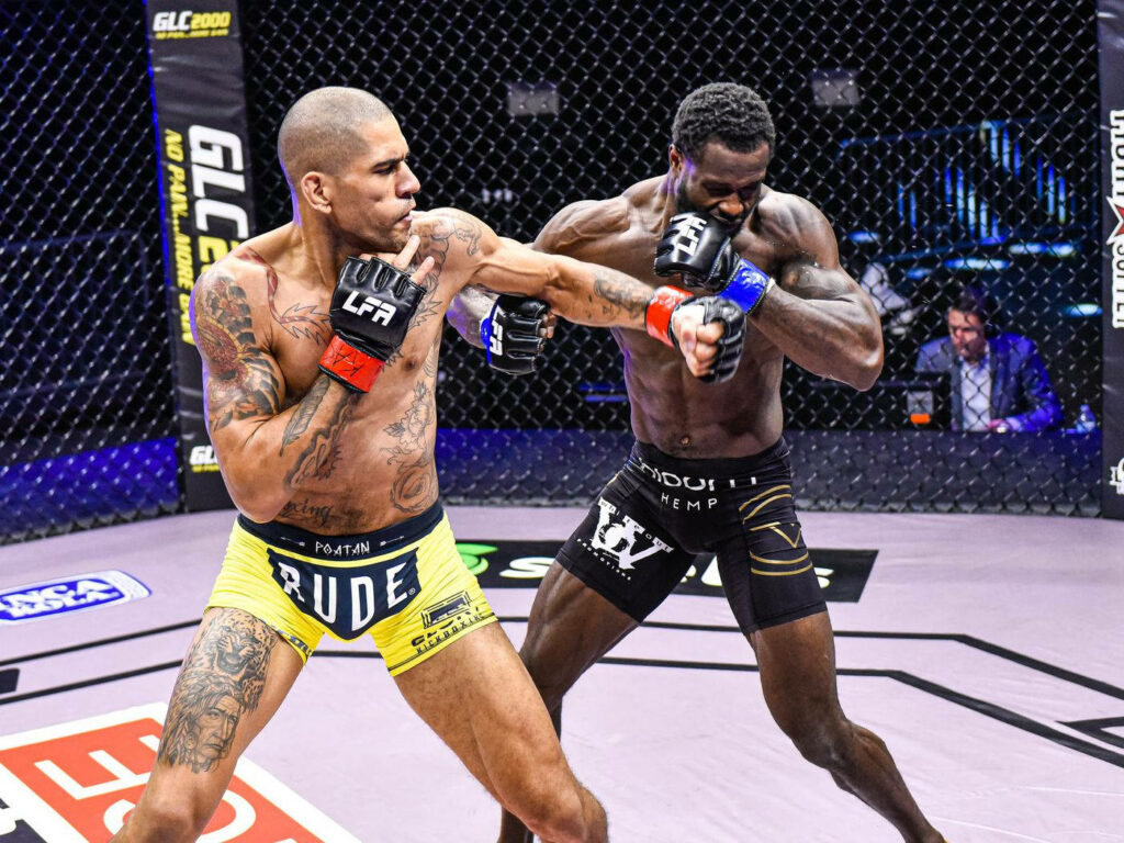 Alex Pereira lands a powerful punch in MMA fight inside cage with intense action wallpaper background