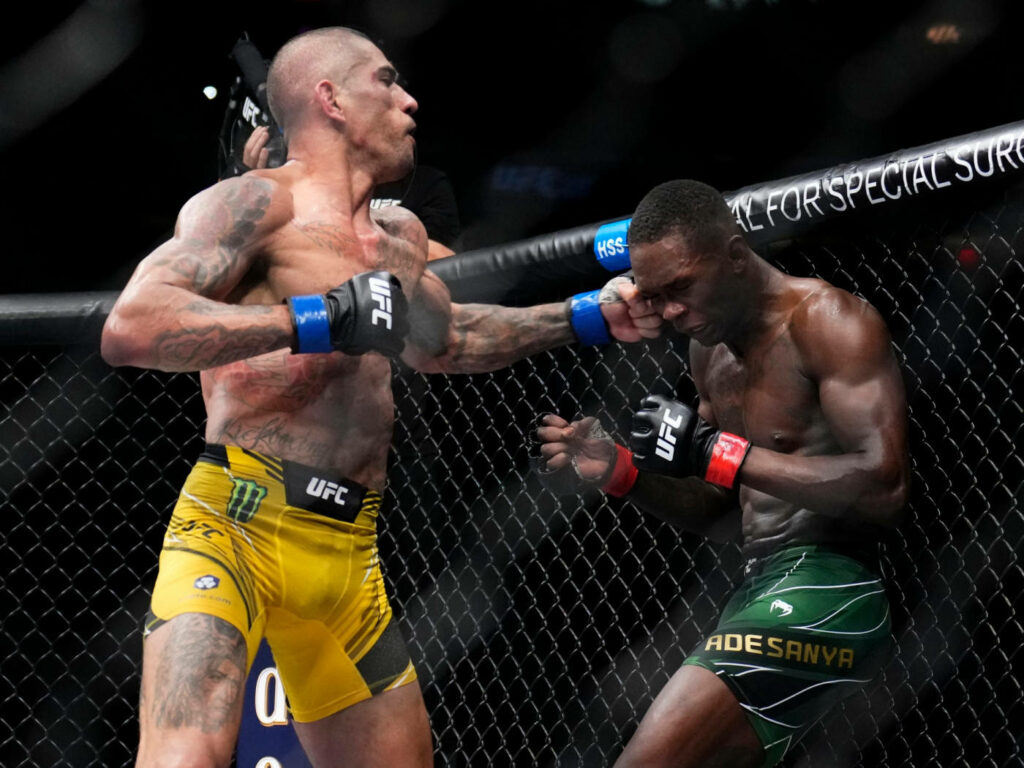 Alex Pereira lands a powerful UFC punch showcasing intense action and athleticism wallpaper