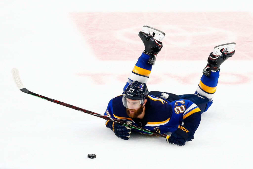 Alex Pietrangelo skating fast in full hockey gear controlling puck during intense game action Wallpaper