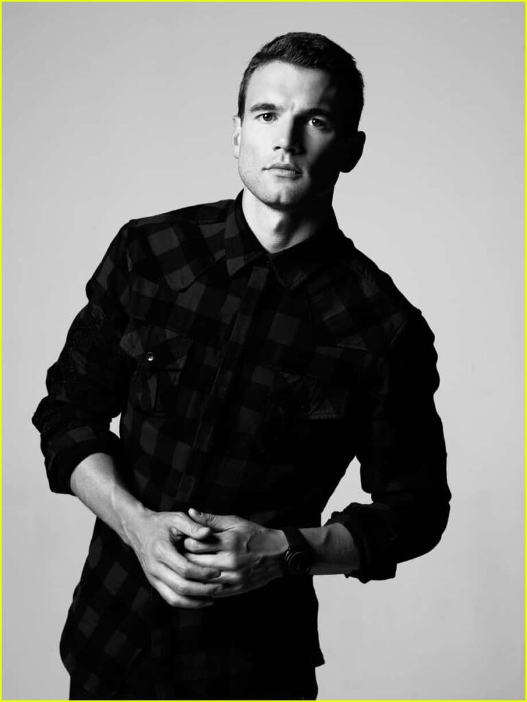 Monochrome portrait of Alex Russell in checkered shirt with confident contemplative expression wallpaper