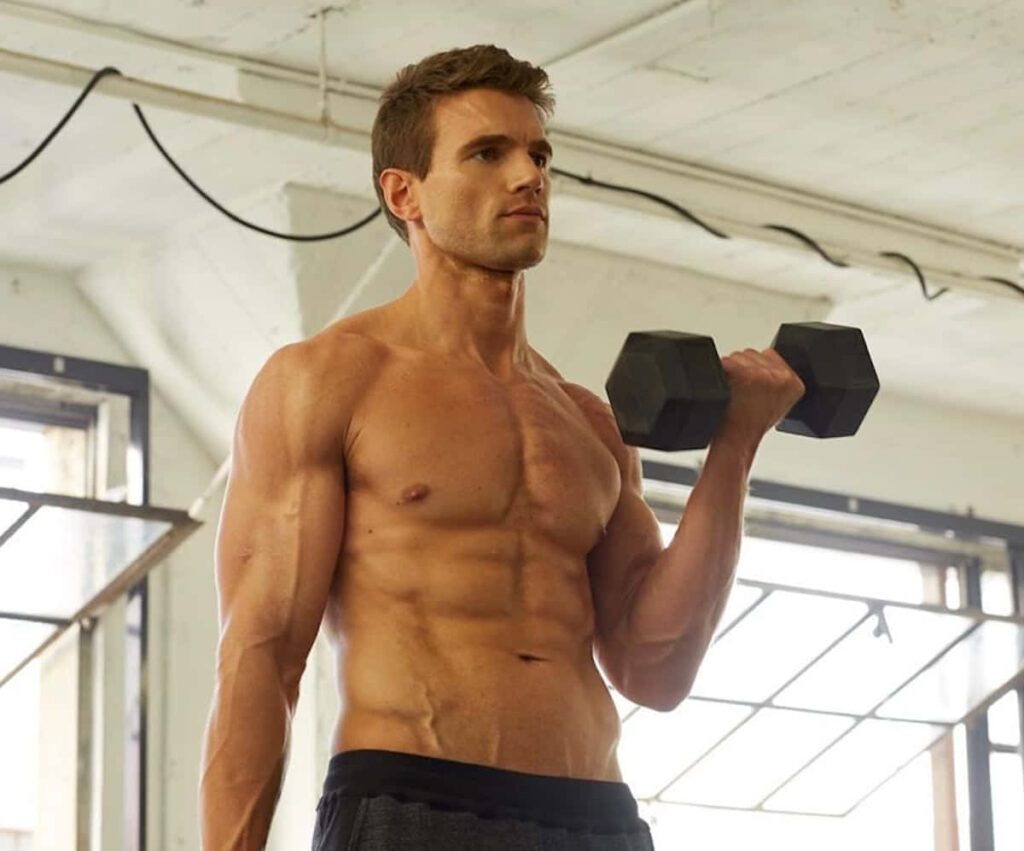 Alex Russell muscular physique dumbbell workout modern gym wallpaper fitness background