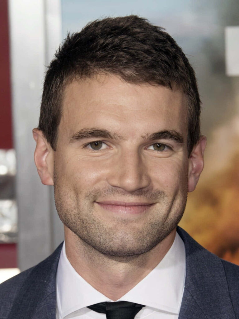 Alex Russell smiling warmly in suit at event perfect wallpaper for actor fans background