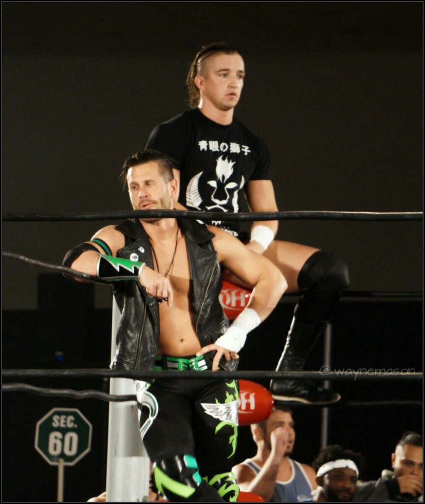 Pro wrestlers Alex Shelley and partner in the ring showing teamwork at Impact Wrestling wallpaper