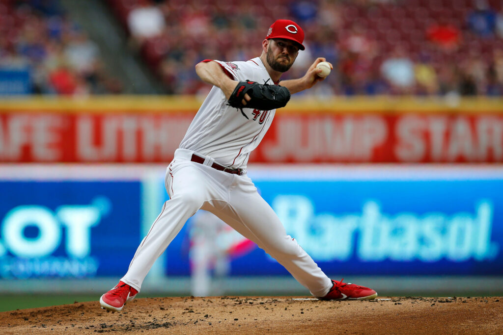 Alex Wood pitching in Cincinnati Reds uniform focused on mound during baseball game wallpaper