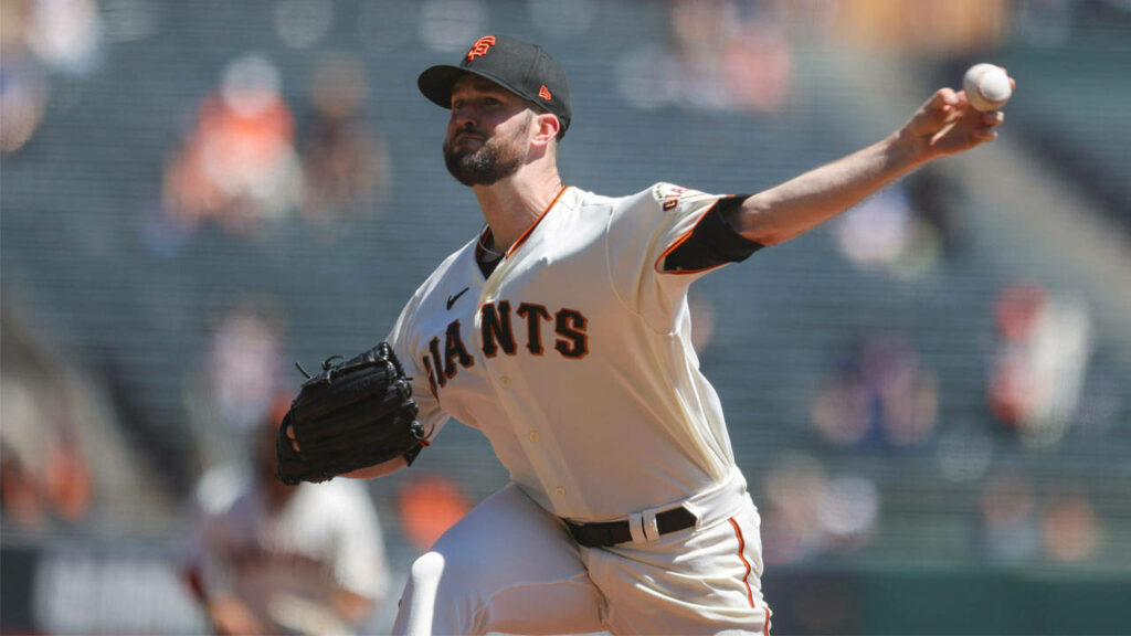 Alex Wood pitching in San Francisco Giants uniform on mound during intense baseball game action Wallpaper