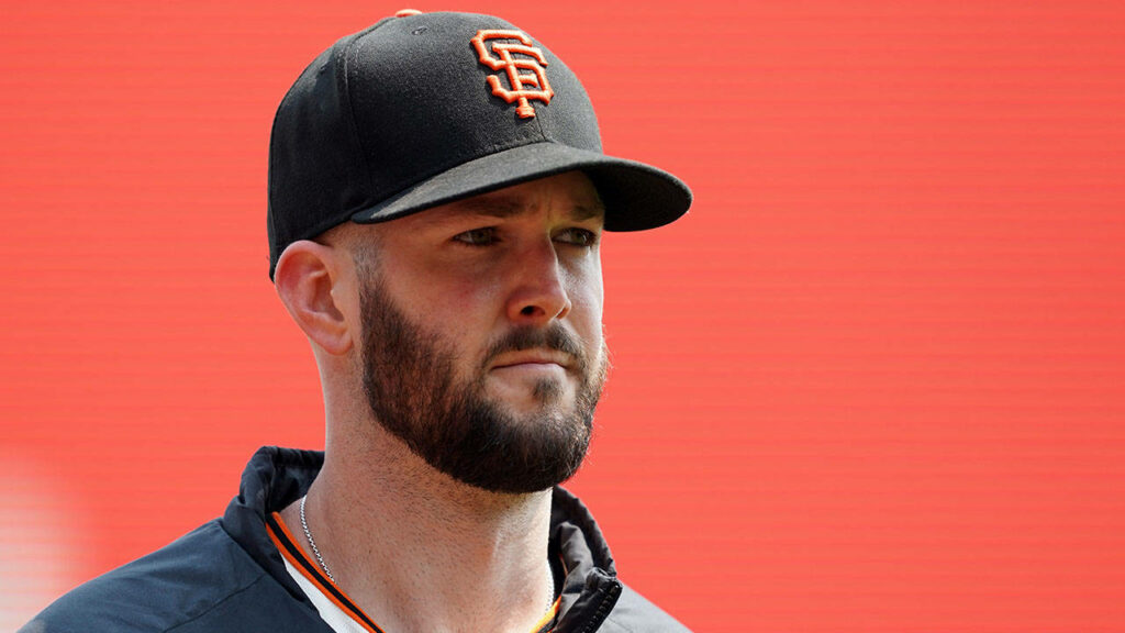 Pitcher Alex Wood in San Francisco Giants cap and jacket with vibrant red background wallpaper